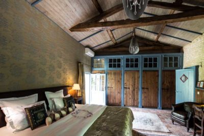 Portail en bois vert foncé avec détails ajourés, ouvert sur un jardin fleuri du Marais Poitevin, suite Ostence.4 de Portail en marais Poitevin - Suite Ostence